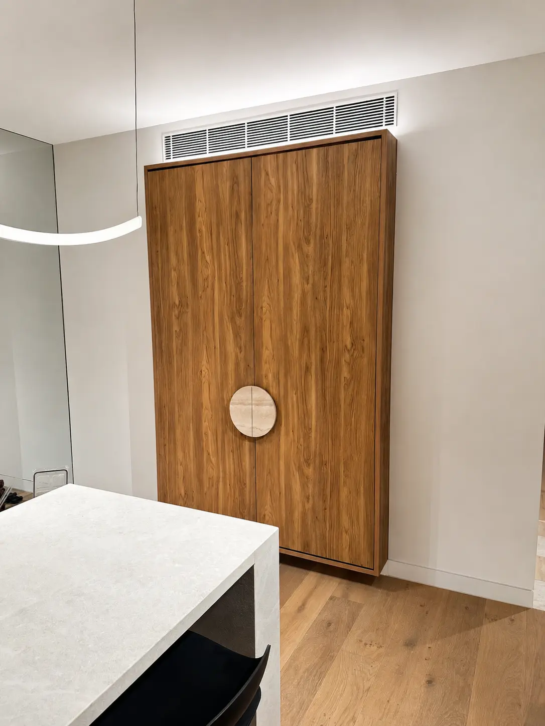 Closed timber feature cabinet with circular stone handles