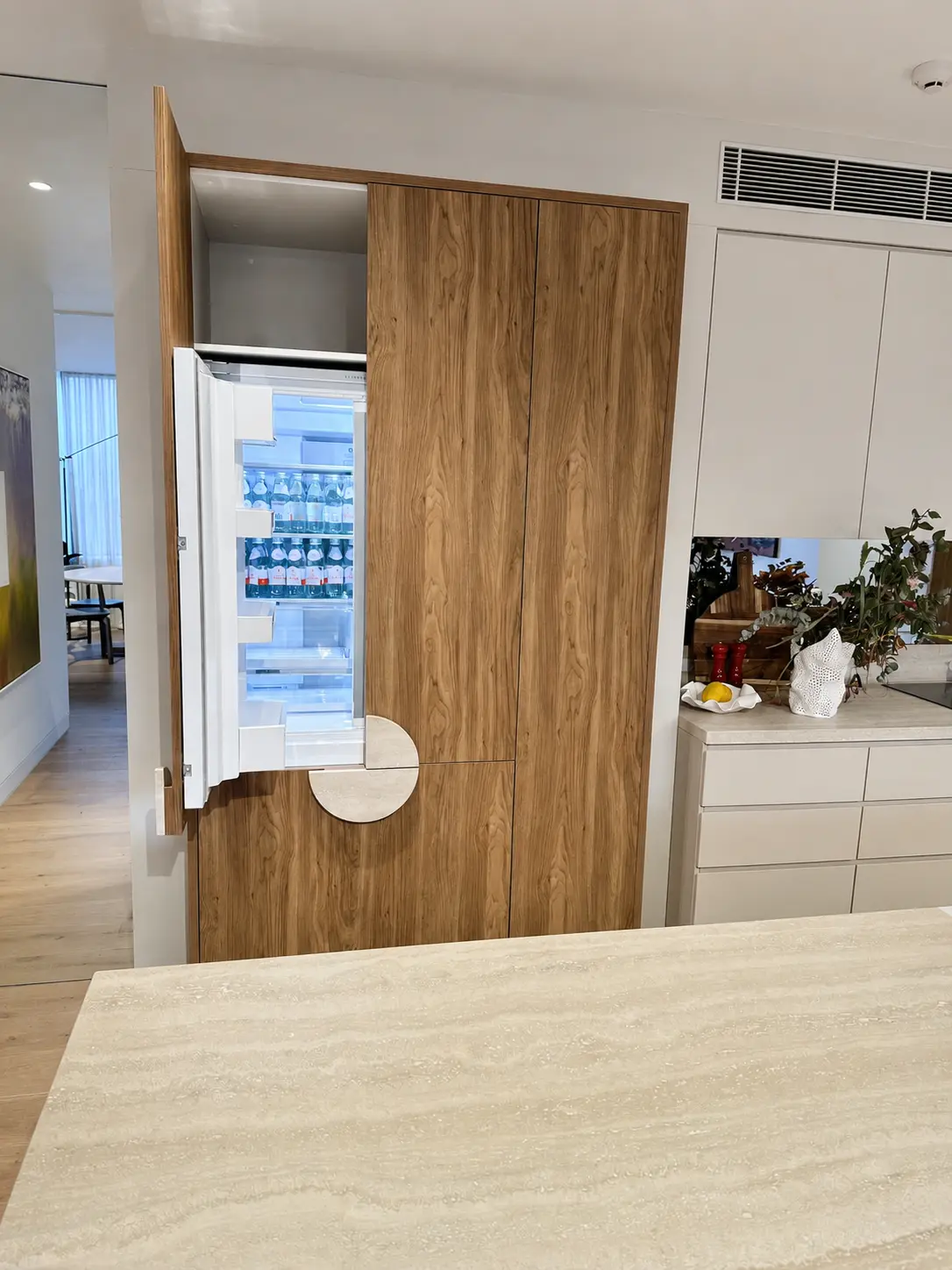 Integrated refrigerator concealed behind custom timber joinery